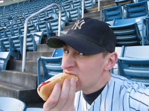 Geoff Welch eating a hot dog at Yankee Stadium