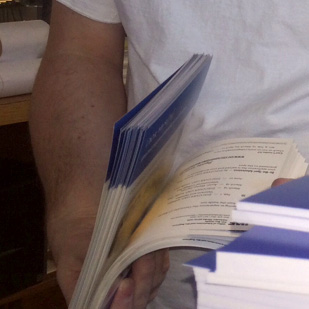 Travis Lewis flipping through a mailing for UAF Admissions